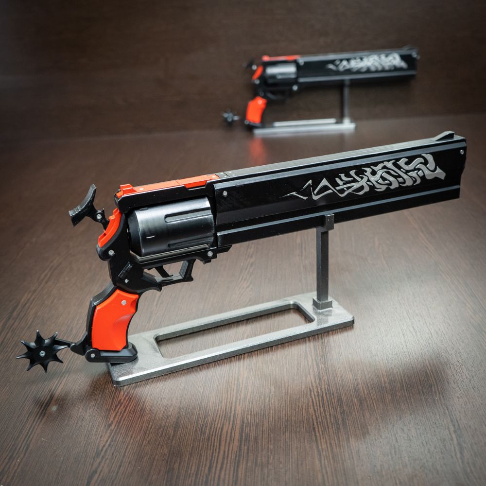 Toy gun with orange accents on a wooden surface