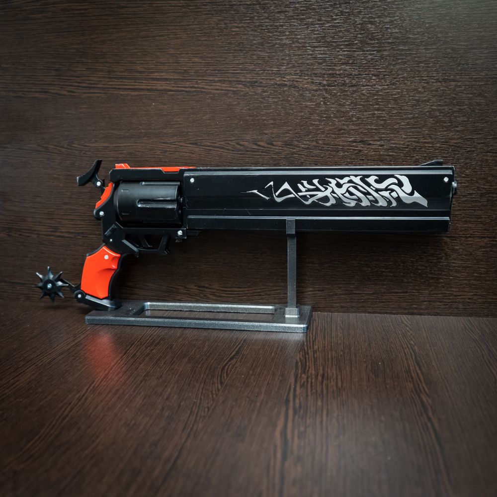 Black and orange toy gun on a wooden surface