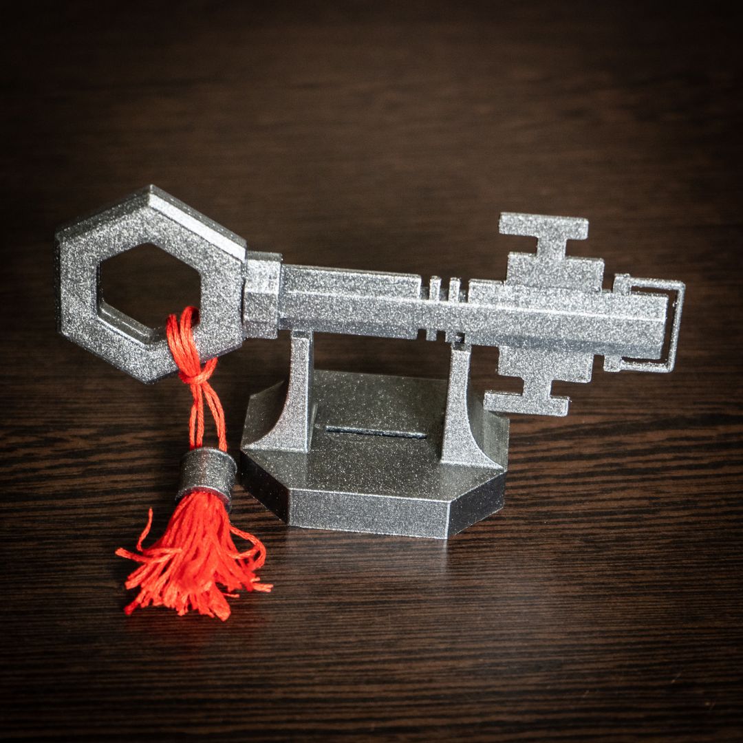 Expedition 33 video game quest item key model with display stand