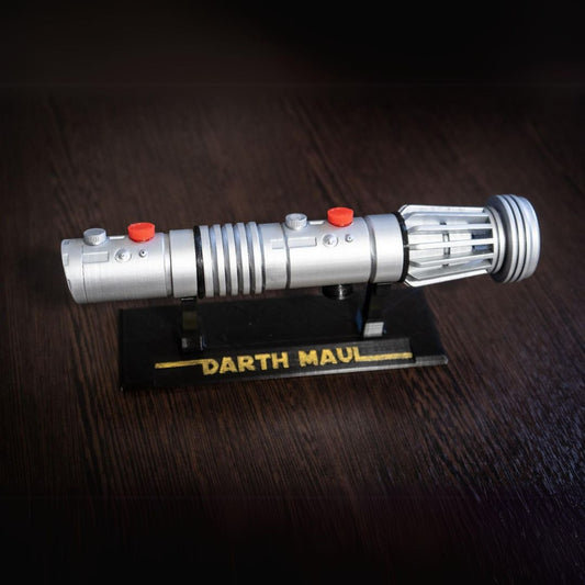 Darth Maul single-bladed lightsaber replica prop made of durable plastic on a display stand labeled Darth Maul
