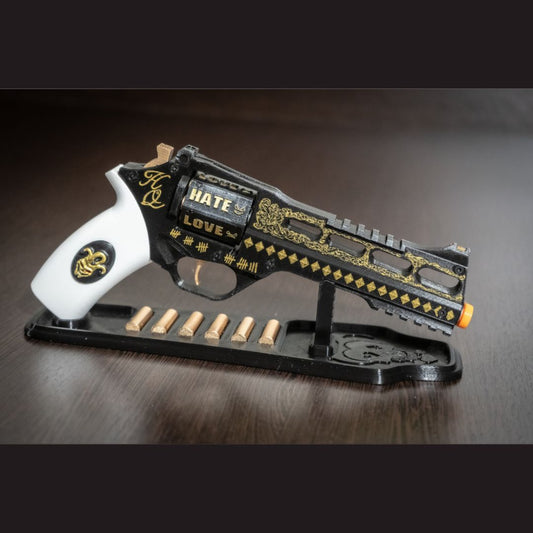 Harley Quinn's Revolver movie-accurate 3D printed cosplay prop with black and gold design, white grip, and display stand with six bullets