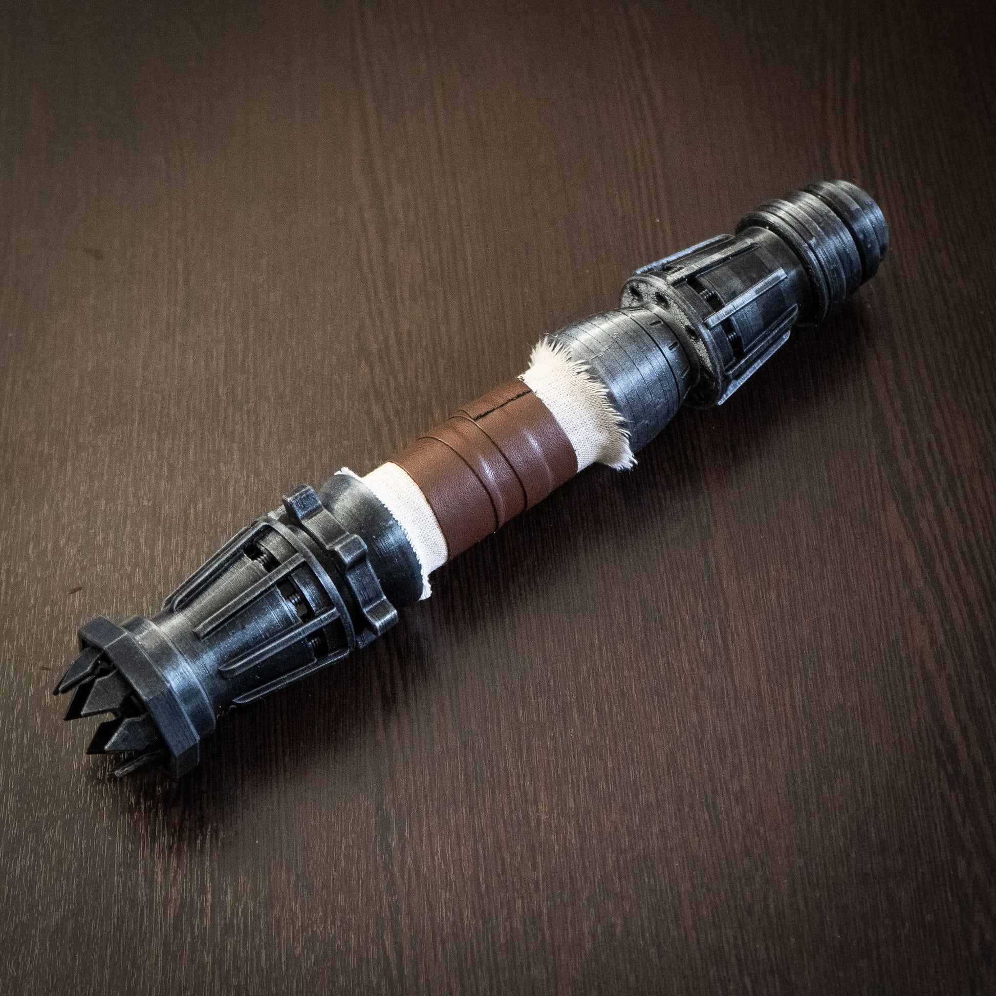 Detailed view of the mechanical staff-based design on Rey's 3D printed lightsaber
