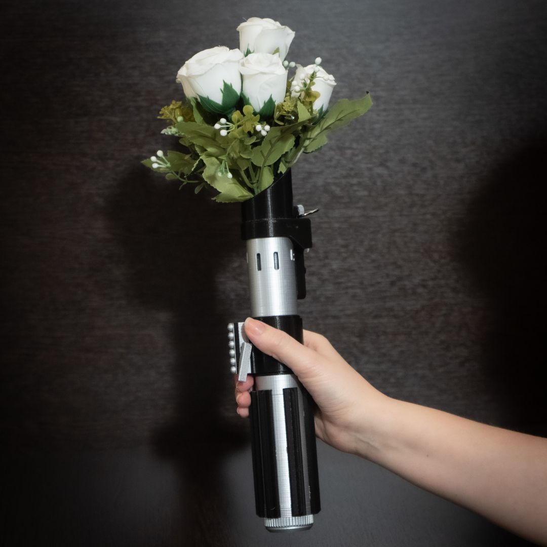 Darth Vader lightsaber hilt used as a Star Wars wedding bouquet holder