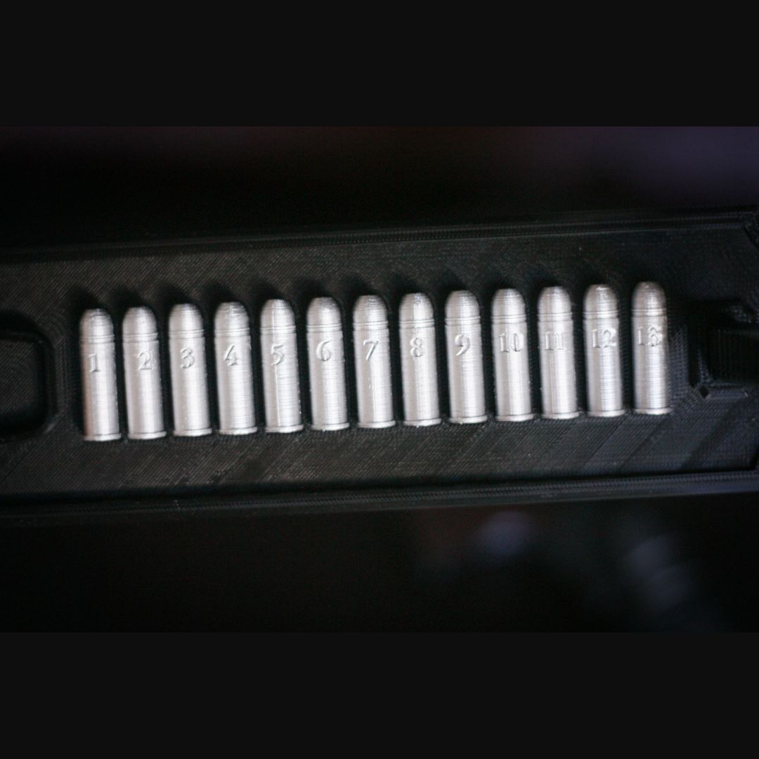 Black display stand with 13 custom replica bullets for collectors