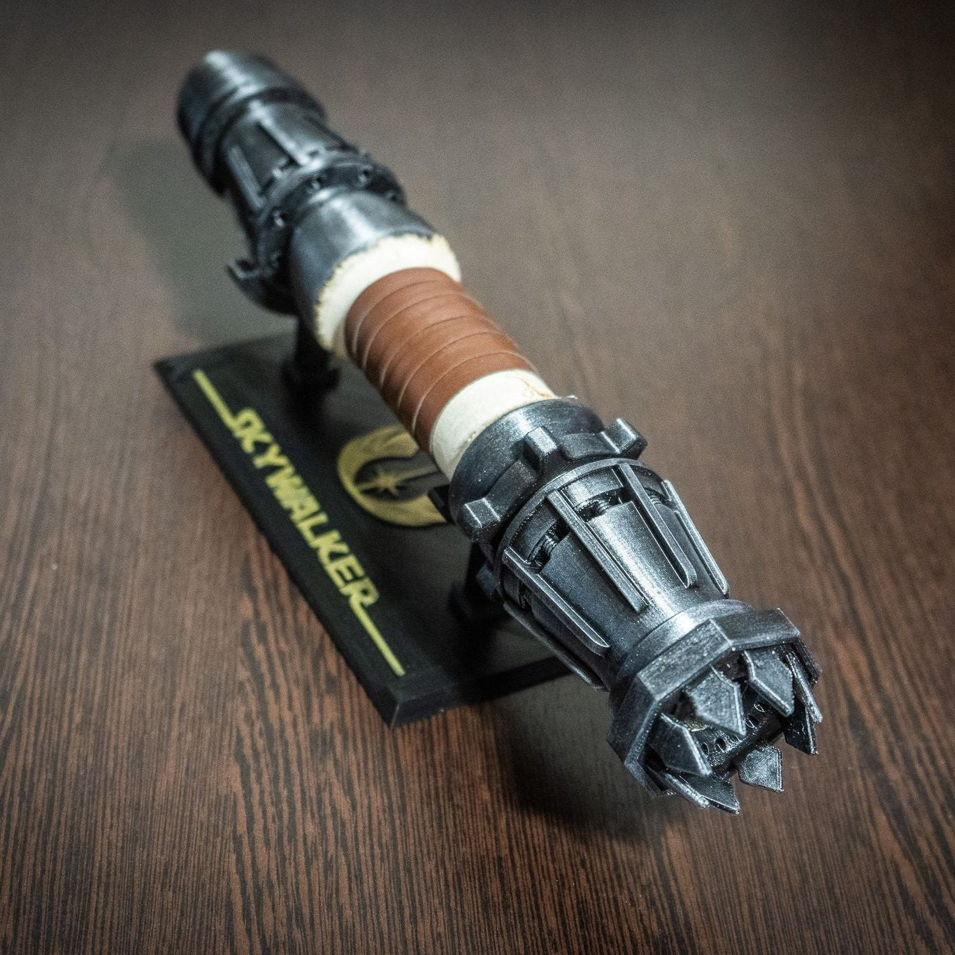 Rey Skywalker lightsaber prop shown from the emitter view with mechanical dials