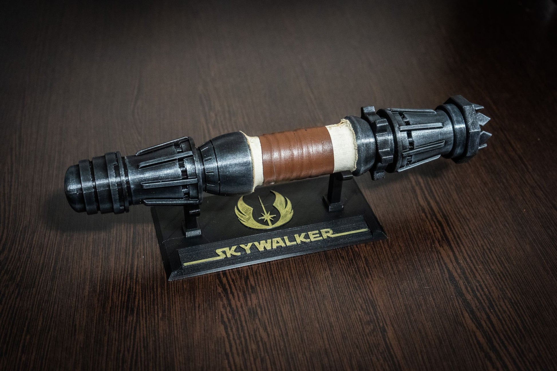 Cosplayer holding the 350mm Rey lightsaber replica in a Jedi costume